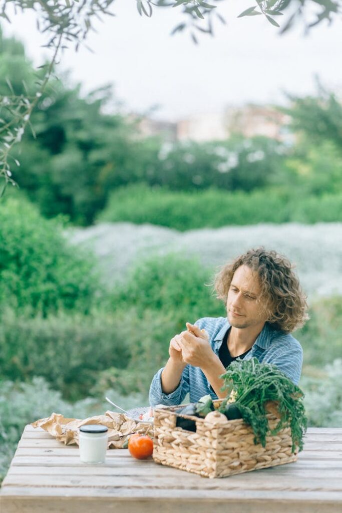 Crafting Captivating Headlines: Your awesome post title goes here An adult man sitting outdoors enjoying fresh organic produce, surrounded by nature.